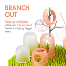 Boon LAWN drying rack featuring TWIG and STEM for hanging small parts, with colorful drying cups and grass-like base.