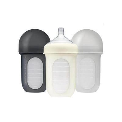 Boon Nursh 8oz bottle three-pack in gray, white, and gray multi colors with measurement markings on the sides.