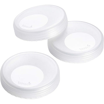 Transparent storage caps from Boon NURSH, three-pack, feature a smooth design with a raised center logo.
