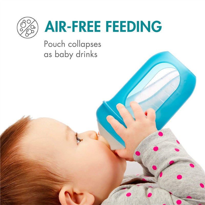 Boon NURSH Silicone Pouch Bottle being used by a baby for air-free feeding, showcasing its collapsible design.