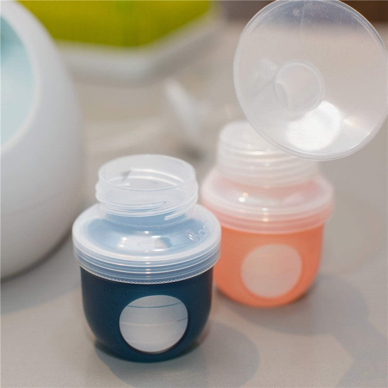 Boon NURSH Pump Adapter set, featuring a blue and a pink adapter with transparent lids, designed for Spectra & Avent bottles.