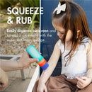 Sunscreen applicator in use with a child, showing application of sunscreen from a blue and green bottle with a foam sponge tip.