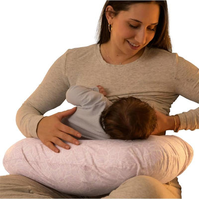 Boppy Nursing Pillow in blush butterflies pattern supports a mother breastfeeding her infant comfortably.