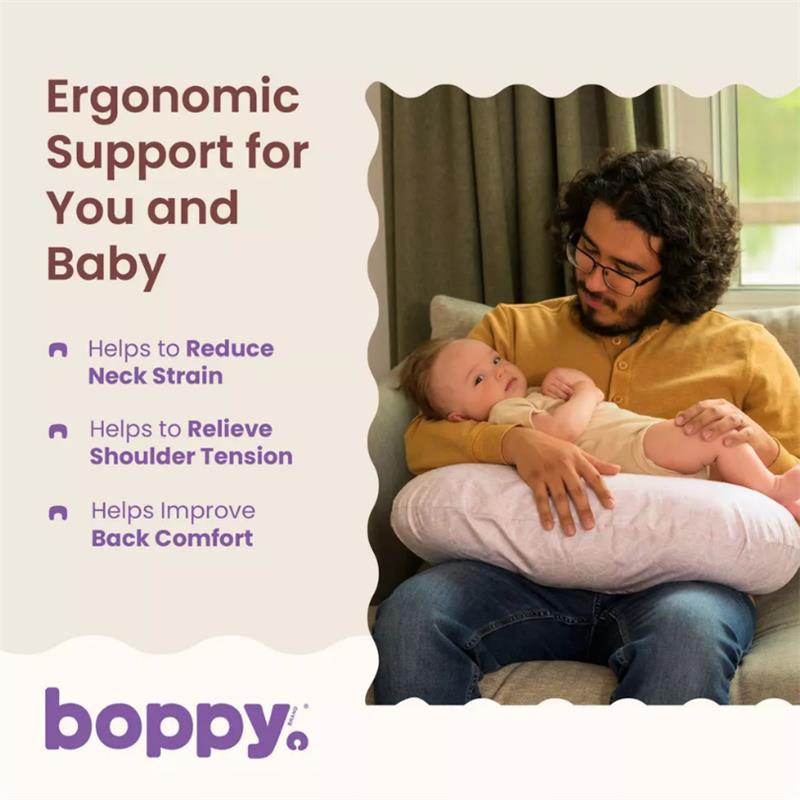 Boppy Nursing Pillow in Blush Butterflies, providing ergonomic support for a parent holding a baby, highlights comfort benefits.