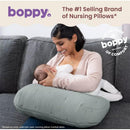 Boppy Nursing Pillow Luxe in Chestnut Muslin being used by a woman nursing a baby, showcasing its comfort and support.