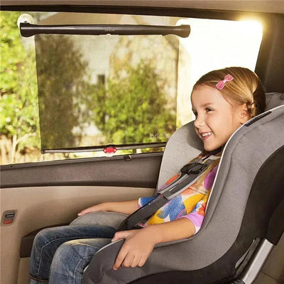 Sun safety car window roller shade by Munchkin - Brica, with a girl smiling in a car seat next to the shade.