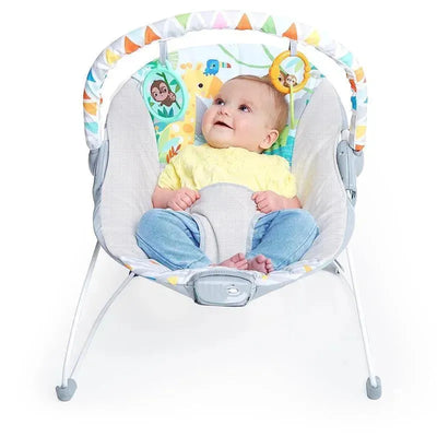 Infant in a Bright Starts baby bouncer with soothing vibrations, colorful animal-themed seat, smiling and relaxed.