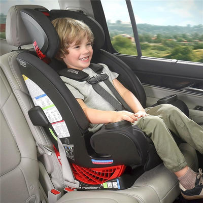 Britax One4Life All in One Convertible Car Seat in Raven Black, with a smiling child seated inside, secured with seatbelt.