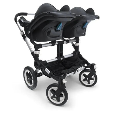 Bugaboo Donkey Twin Car Seat Adapter for Turtle/Nuna/Maxi-Cosi, featuring dual car seats attached to a stroller frame.