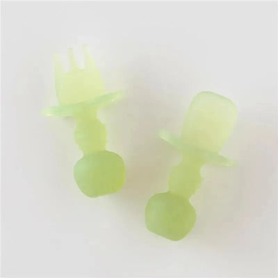Silicone baby utensils set in green jelly color, including a fork and a spoon with soft, ergonomic handles.