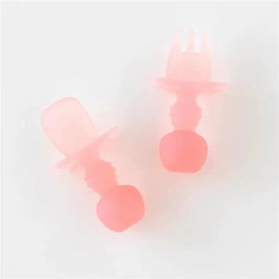 Silicone baby utensils set in pink jelly color, featuring a spoon and fork with ergonomic handles designed for infants.