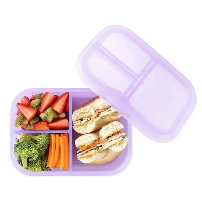 Bumkins purple jelly bento box with three compartments containing strawberries, kiwi, carrots, broccoli, and sandwiches.