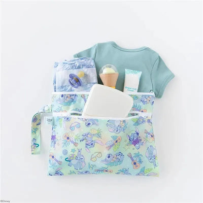 Bumkins Wet/Dry Clutch in Aloha design, filled with a shirt, diapers, wipes, cream, and a pacifier.