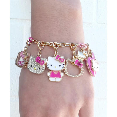 Gold charm bracelet featuring multiple Hello Kitty charms, including a locket and characters in various styles.