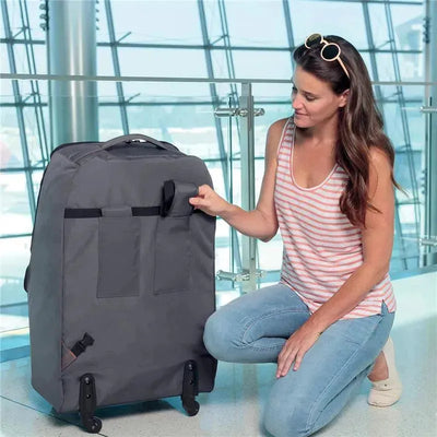 Chicco Car Seat Travel Bag in anthracite color, displayed with a woman adjusting its pocket at an airport.