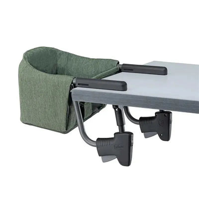 Chicco Fastlock 360 Hook-On Chair in Moss, securely attached to a table with adjustable clamps and a soft green fabric seat.