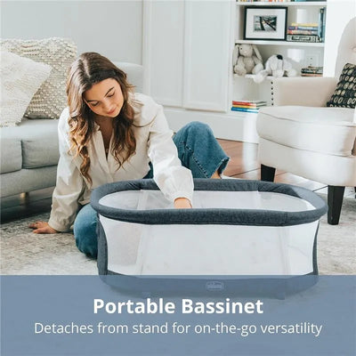 Chicco LullaGlide™ 3-in-1 Stationary Baby Bassinet, showcasing a woman interacting with a portable, mesh-sided bassinet.