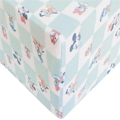 Premium crib sheet featuring Mickey Mouse and friends in a playful checkerboard pattern with pastel colors.