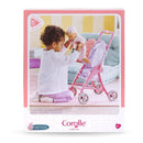 A child plays with a Corolle Dolls Floral Pushchair, preparing to place a 30 cm doll into it.