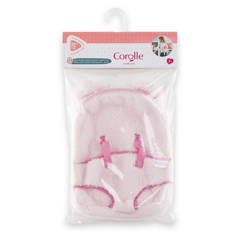 Plush pink baby doll carrier backpack with straps, designed for 12-inch dolls, packaged for retail display.