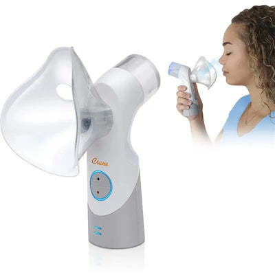 Cordless Crane warm and cool mist inhaler in use, featuring a clear nozzle and control buttons, shown with a user.