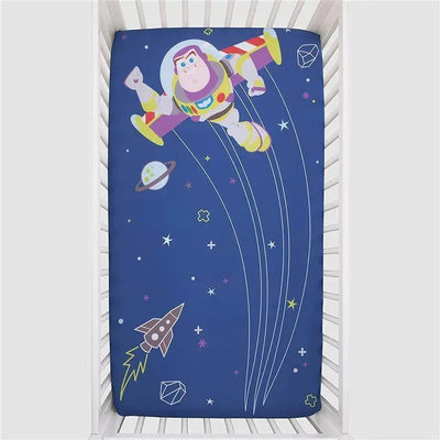 Crown Crafts Disney Buzz Lightyear crib fitted sheet featuring Buzz Lightyear flying in space with planets and stars.