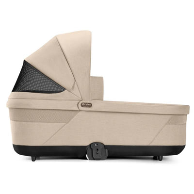 Cybex Balios Cot S Lux in Almond Beige, featuring a stylish design with a mesh ventilation panel and secure fastening.