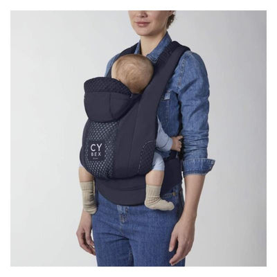 Cybex Coya Carrier in Royal Blue, featuring a woman with a baby safely secured in a comfortable position.