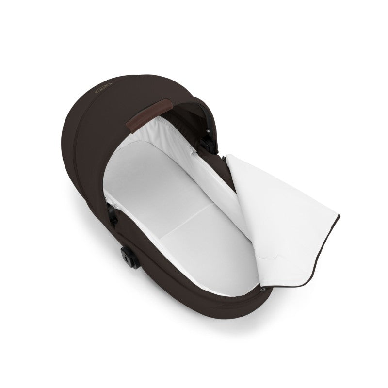 Cybex Gazelle S Cot in chocolate brown, featuring a foldable design and a spacious white interior.