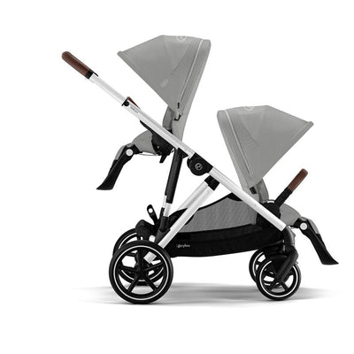 Cybex Gazelle S Stroller with a silver frame and stone grey seat, featuring two adjustable canopies and a spacious storage basket.