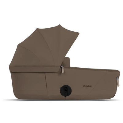 Cybex Mios/Coya Fold Lux Carry Cot in Coconut Brown, featuring a compact design and a protective canopy.