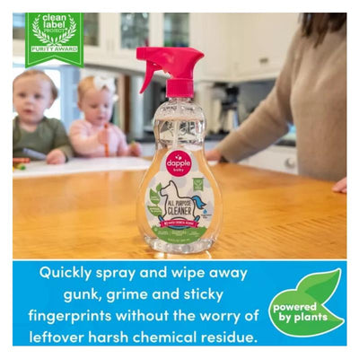 Dapple All Purpose Cleaner Spray, 16.9 oz, on a table with children drawing in the background, featuring a pink spray nozzle.