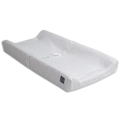 Contoured changing pad in grey stripe, featuring a cooling cover and safety strap for secure diaper changes.