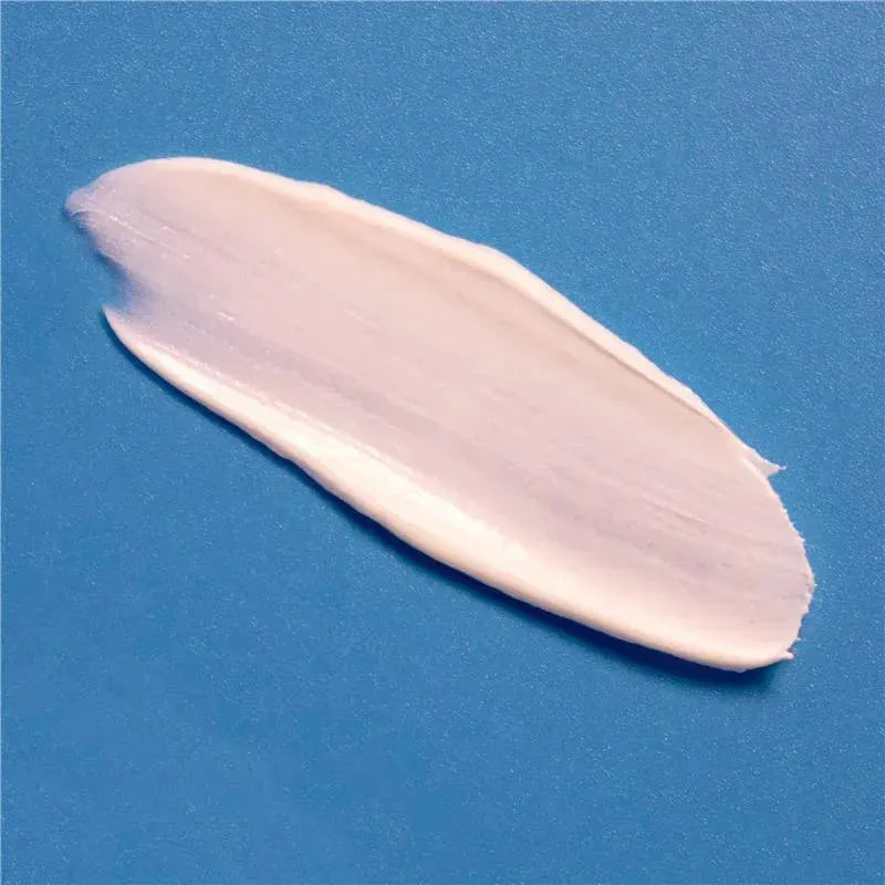A smooth, creamy layer of diaper rash cream on a blue background, highlighting its soothing texture for babies.