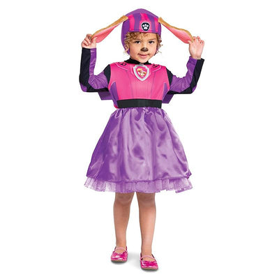 Toddler wearing a pink and purple Skye costume from Paw Patrol, complete with a hat, dress, and shiny pink shoes.
