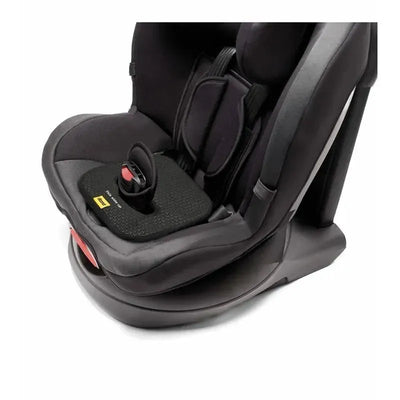 Doona Lab SensAlert Pad placed in a child car seat, featuring a textured black surface and a red release button.
