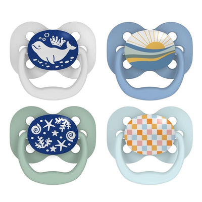 Assorted Dr. Brown Stage 1 pacifiers in blue hues featuring designs of a whale, sunrise, coral, and a checker pattern.