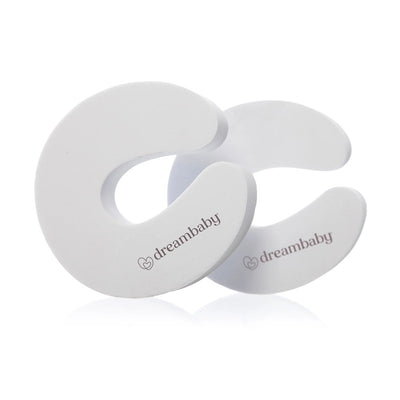 Dreambaby Foam Door Stoppers - 2 pack, featuring white foam C-shaped stoppers with the brand name printed.
