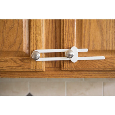 White Dreambaby Slimline Slide Lock securing two wooden cabinet doors, promoting child safety in the kitchen.