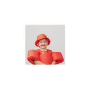 Smiling child wearing a red gingham float suit and matching hat, designed for water safety.