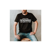 Eden & Eve Surviving Fatherhood One Beer At A Time Graphic Tee Black - Daddy's T-Shirt Image 1