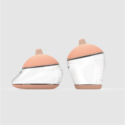 Two baby bottles from the Emulait Starter Kit, featuring a fair nipple color and rounded shape, set against a neutral background.
