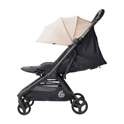 Ergobaby Metro 3 Lightweight Travel Stroller in natural beige with a sunshade, featuring a compact design and storage basket.