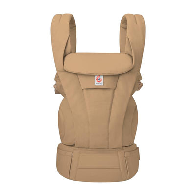 Ergobaby Omni Deluxe Baby Carrier in camel cotton, suitable for newborns to toddlers, featuring padded shoulder straps and a supportive waist belt.