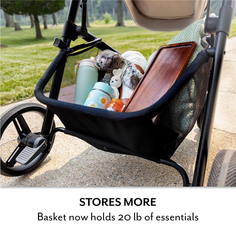 Basket of Evenflo Pivot NXT stroller holding a variety of items like a blanket, toys, water bottles, and a wooden tray.
