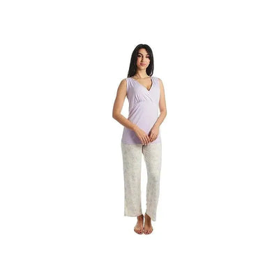 Maternity and nursing pajama set featuring a lavender top and cream pants with floral design, modeled by a standing woman.