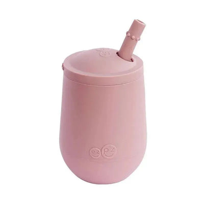 Mini cup with a straw training system in blush color, featuring a round lid and a playful design.