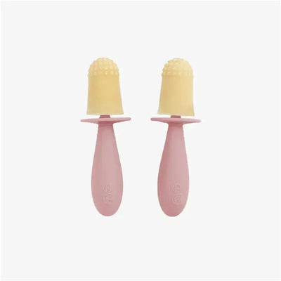 Tiny pink popsicle molds with wands, featuring yellow frozen treats with a textured top for easy gripping.