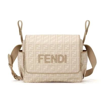 Beige Fendi baby diaper bag featuring the logo and an allover monogram design, with adjustable shoulder straps.