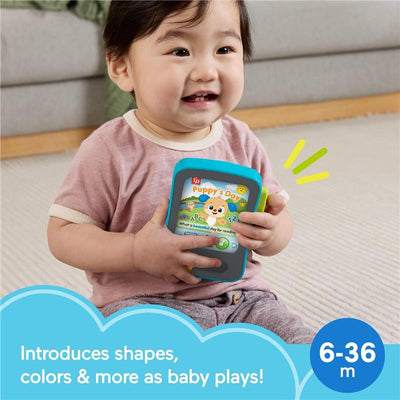 Smiling baby holds the Fisher Price Laugh & Learn Puppy’s Storytime Reader toy, introducing shapes and colors for ages 6-36 months.